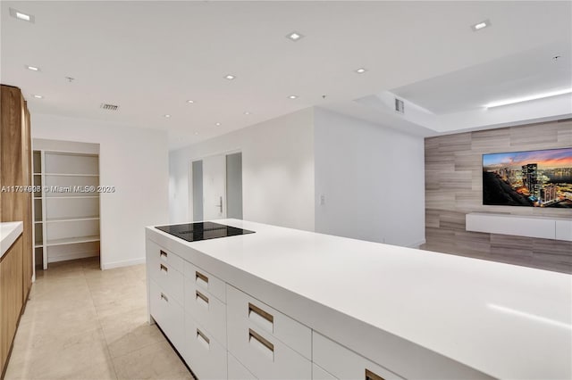 kitchen with white cabinetry and black electric stovetop