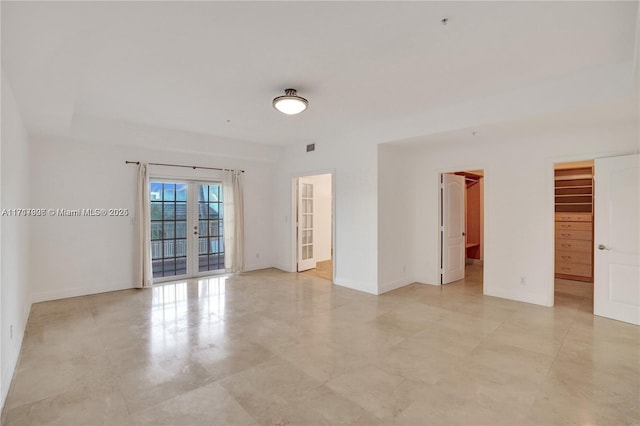 unfurnished room featuring french doors