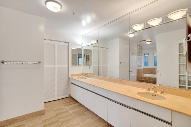 bathroom with vanity, a tub to relax in, and tile patterned floors