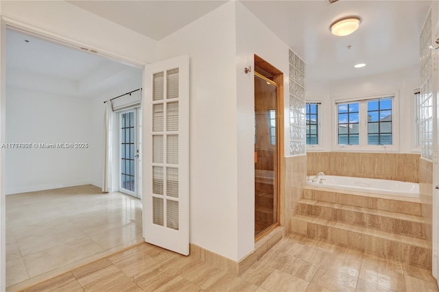 bathroom with tile patterned flooring and independent shower and bath