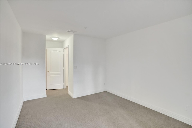 spare room with light carpet