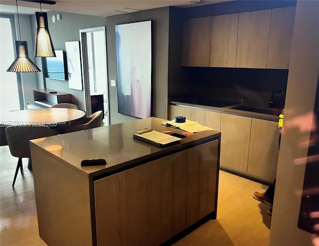 kitchen with a center island, sink, and pendant lighting