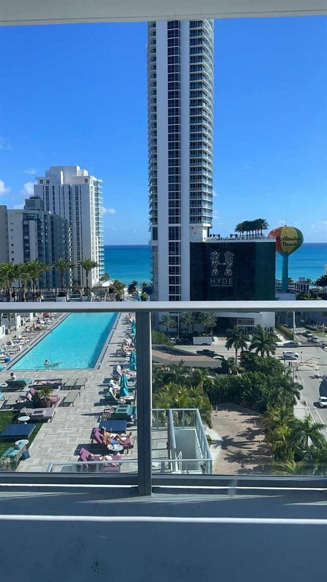 view of swimming pool featuring a water view