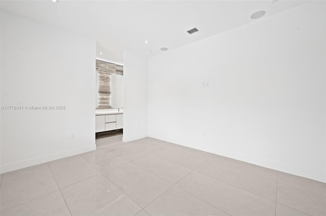 spare room with light tile patterned floors