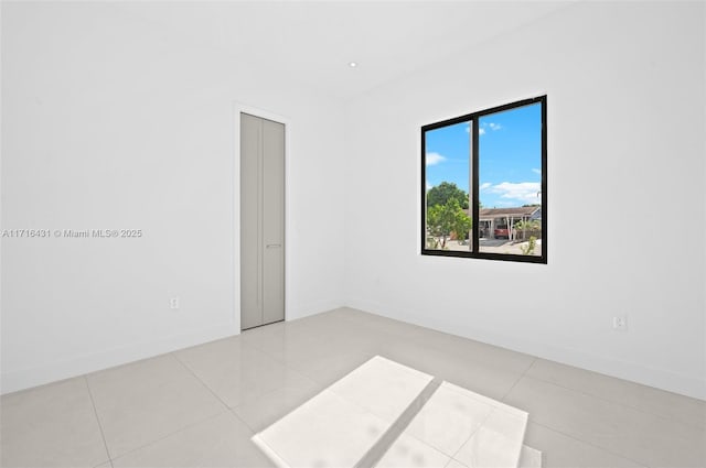 spare room with light tile patterned floors