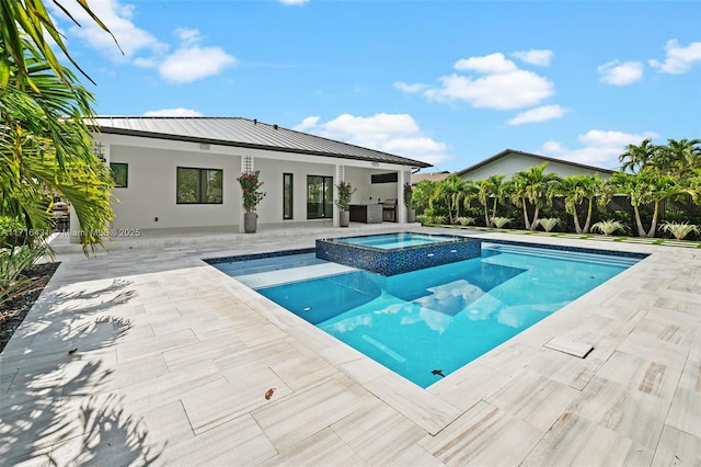 view of swimming pool featuring an in ground hot tub and a patio area