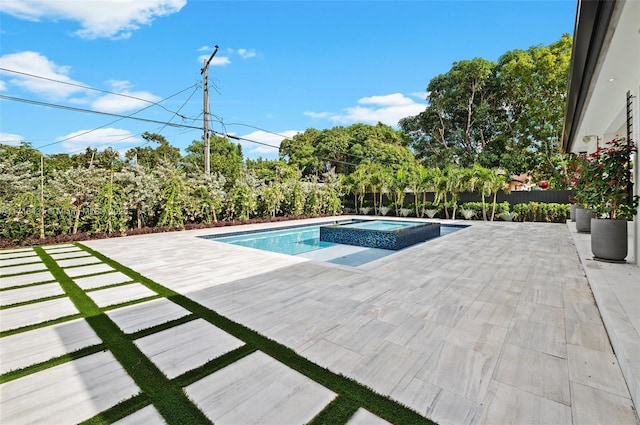 view of swimming pool featuring an in ground hot tub and a patio area