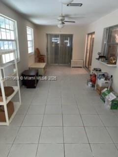 living room featuring tile patterned floors and ceiling fan