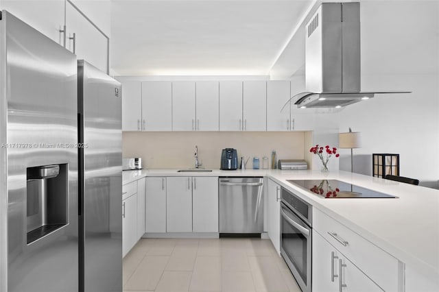 kitchen featuring white cabinetry, island range hood, and appliances with stainless steel finishes