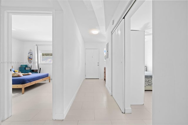 corridor featuring light tile patterned floors