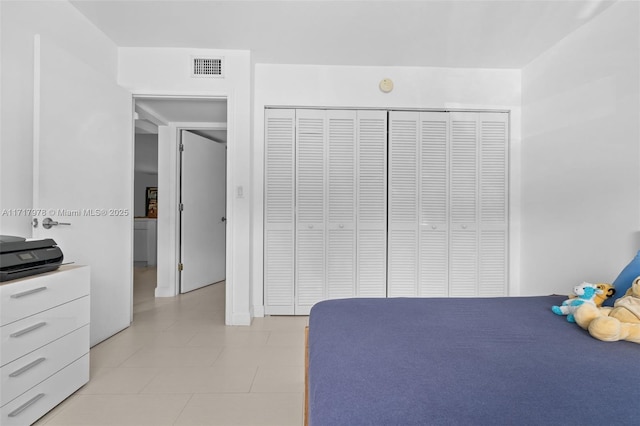 unfurnished bedroom with light tile patterned floors and a closet