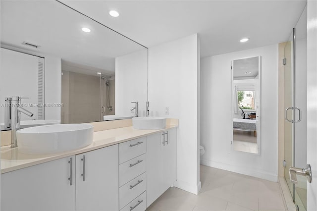 bathroom featuring tile patterned flooring, toilet, vanity, and walk in shower