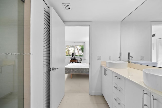 bathroom with tile patterned floors and vanity