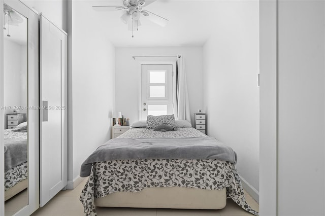 bedroom with light tile patterned floors and ceiling fan