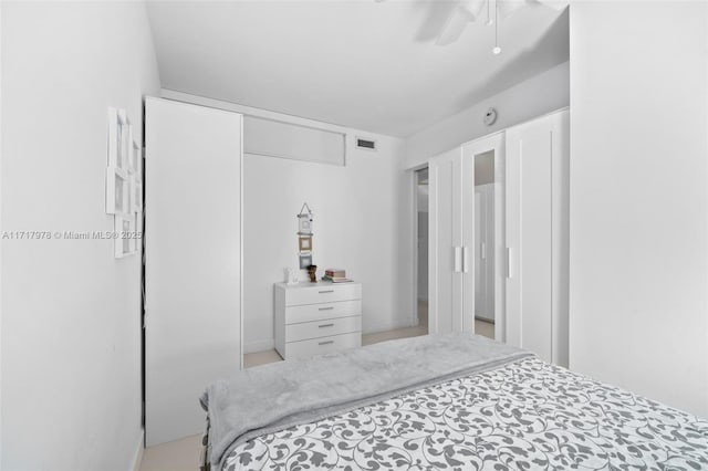 bedroom with ceiling fan and a closet