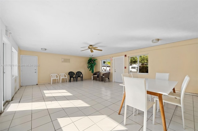 unfurnished dining area with ceiling fan and light tile patterned flooring