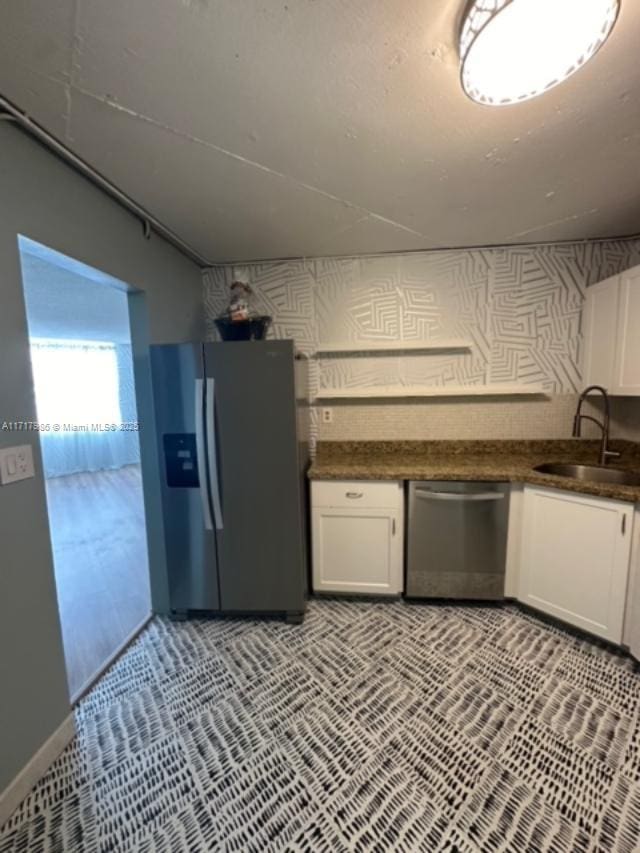 kitchen with white cabinetry, sink, and appliances with stainless steel finishes