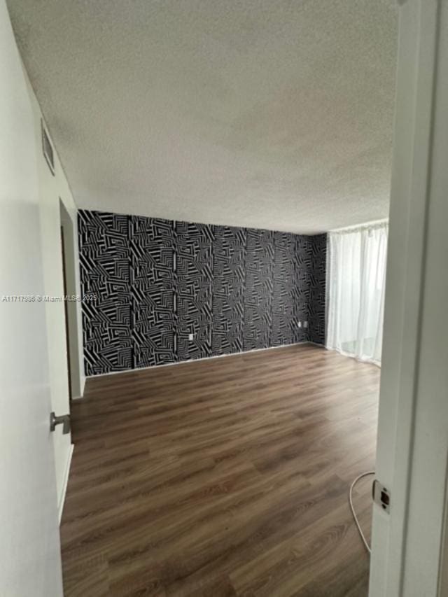 empty room with dark hardwood / wood-style floors