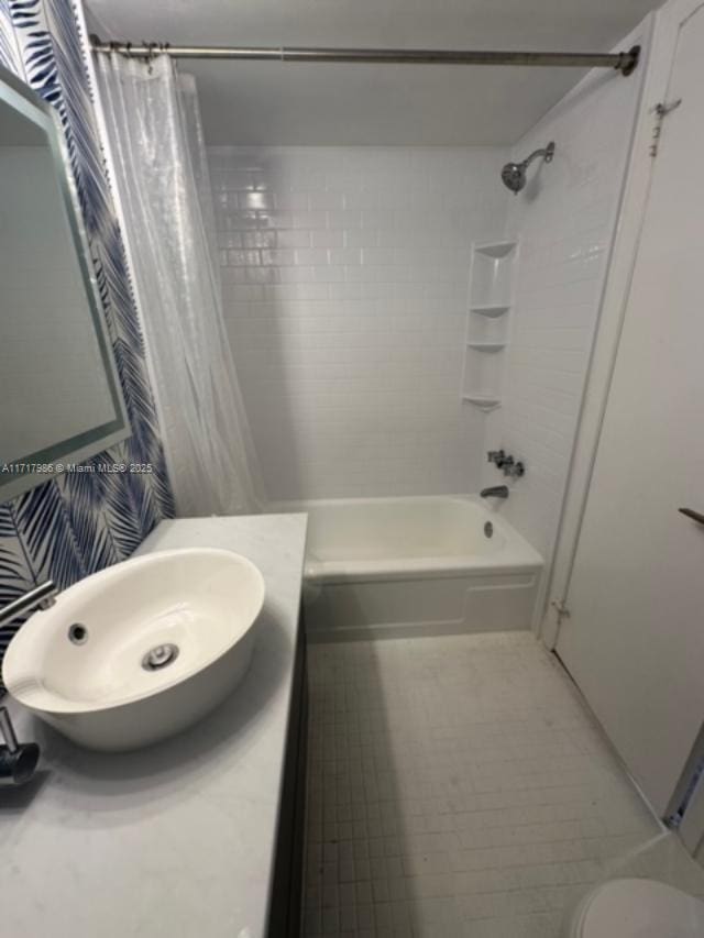 bathroom featuring vanity and shower / tub combo with curtain