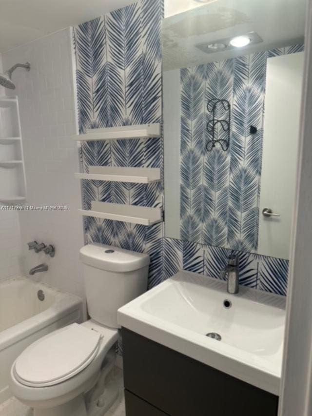 full bathroom with shower / bathing tub combination, vanity, and toilet