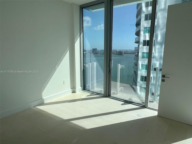 unfurnished room featuring floor to ceiling windows