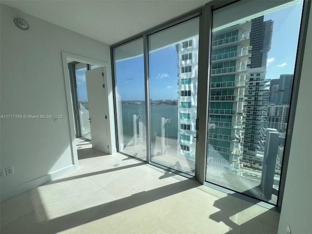 unfurnished room featuring floor to ceiling windows