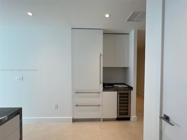 kitchen with light tile patterned floors and beverage cooler