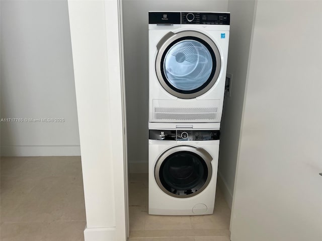 clothes washing area with stacked washer and clothes dryer