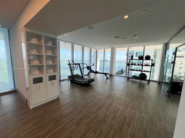 700 NE 26th Ter Unit 2004, Miami, FL 33137 - exercise room with dark wood-type flooring, a wall of windows, and a water view