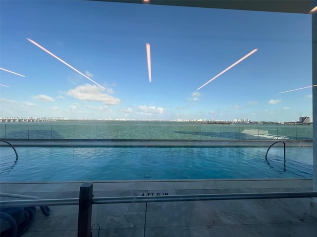 view of pool featuring a water view