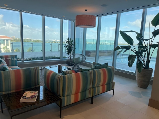 living room featuring a water view and light tile patterned flooring