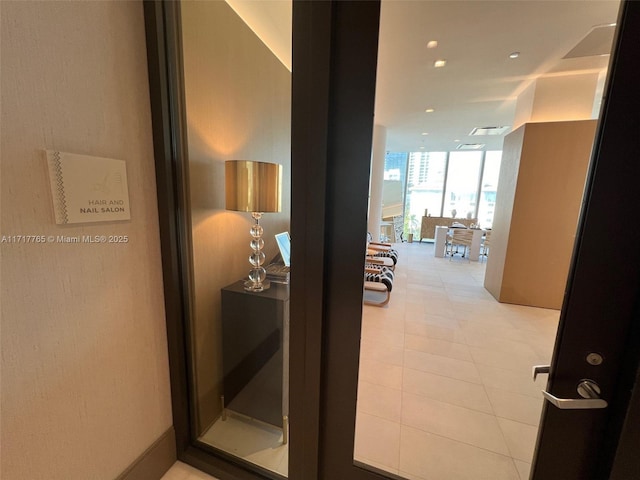 corridor with expansive windows and light tile patterned flooring