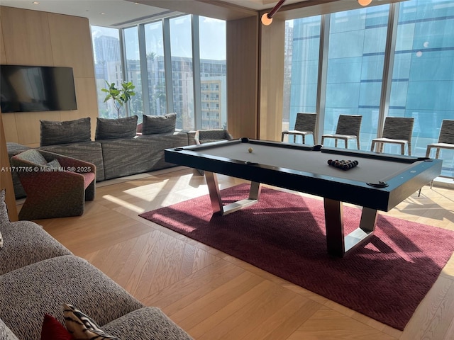 rec room with expansive windows, a healthy amount of sunlight, pool table, and light hardwood / wood-style flooring