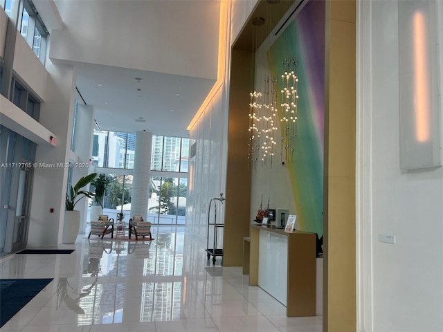 700 NE 26th Ter Unit 2004, Miami, FL 33137 - hallway featuring light tile patterned flooring, plenty of natural light, and a towering ceiling