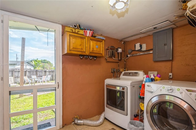 laundry room featuring electric panel, cabinets, and independent washer and dryer