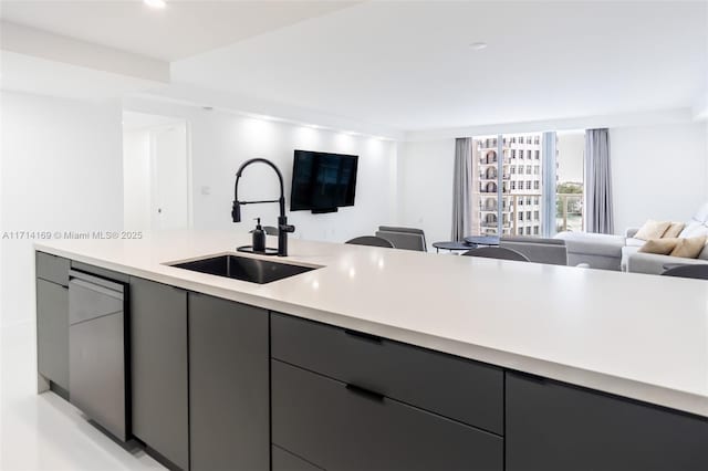 kitchen with gray cabinetry, sink, and dishwasher