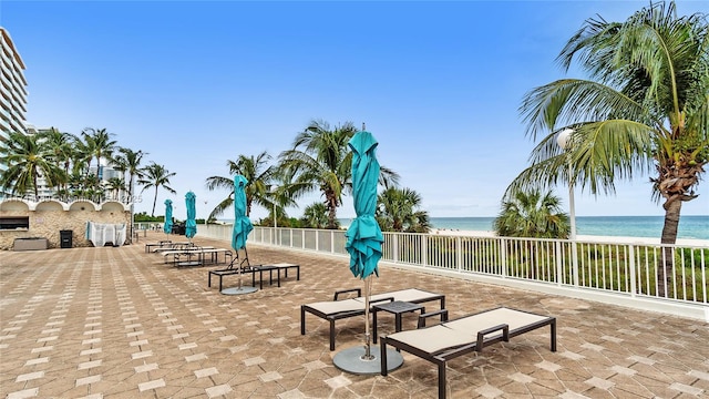 surrounding community featuring a water view and a view of the beach