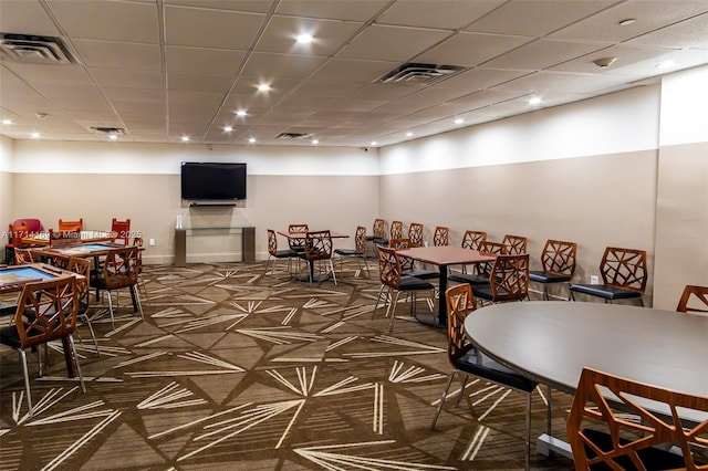 interior space featuring a drop ceiling and dark carpet