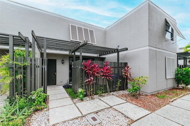 back of property featuring a pergola