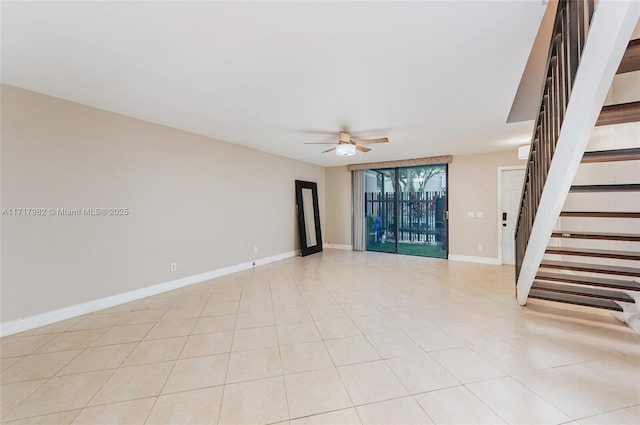 tiled empty room featuring ceiling fan