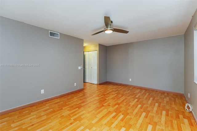 spare room with ceiling fan and light hardwood / wood-style floors