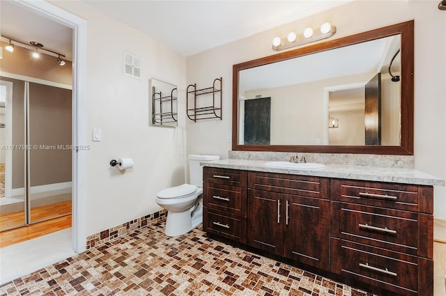 bathroom with tile patterned floors, vanity, and toilet