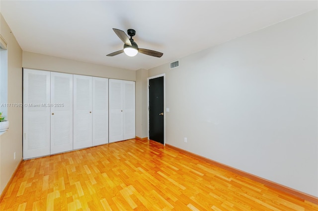 unfurnished bedroom featuring hardwood / wood-style floors and ceiling fan