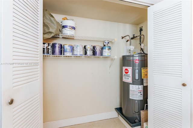 utility room featuring water heater