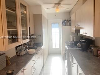 kitchen with white cabinets and ceiling fan