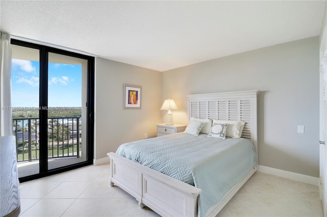 tiled bedroom with access to exterior and expansive windows