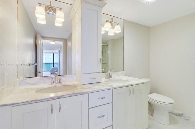 bathroom featuring vanity, an enclosed shower, and toilet