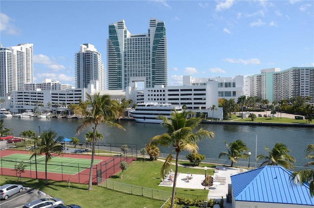 view of water feature with fence and a city view