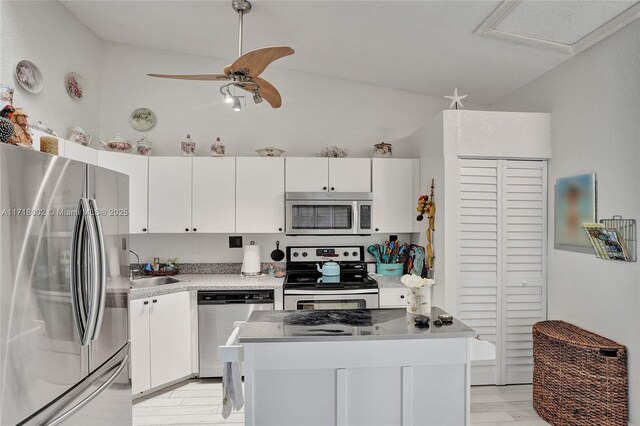 kitchen with appliances with stainless steel finishes, a textured ceiling, light hardwood / wood-style flooring, and white cabinetry