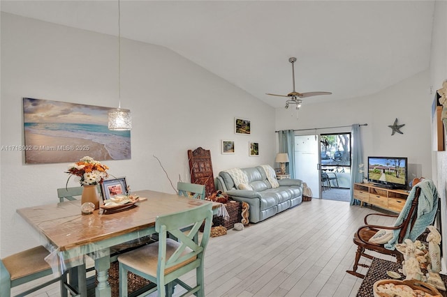 living room featuring ceiling fan, light wood-type flooring, and lofted ceiling